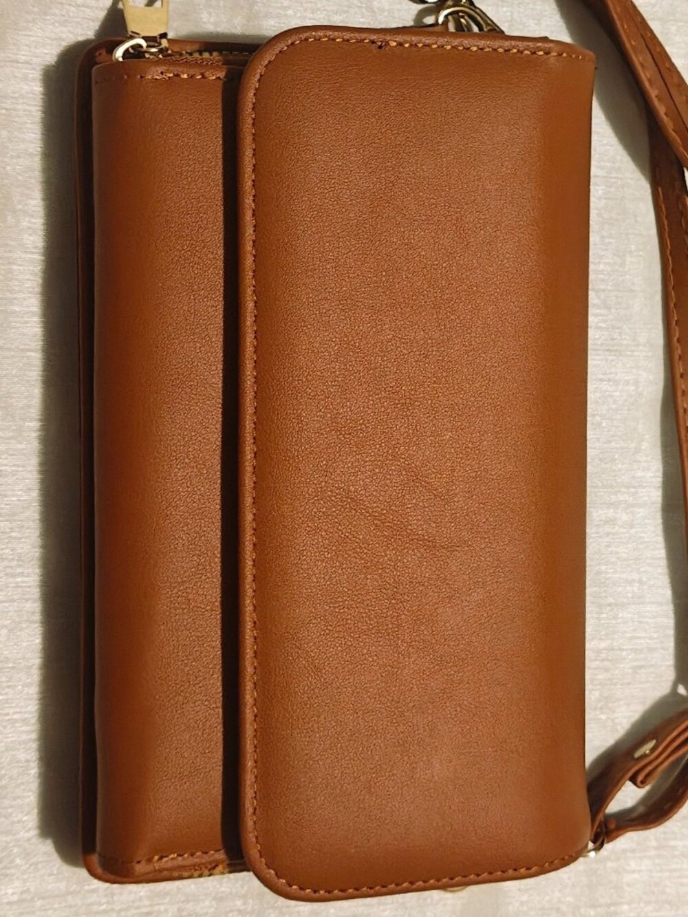 Tan faux-leather mini crossbody bag with front zipper compartment